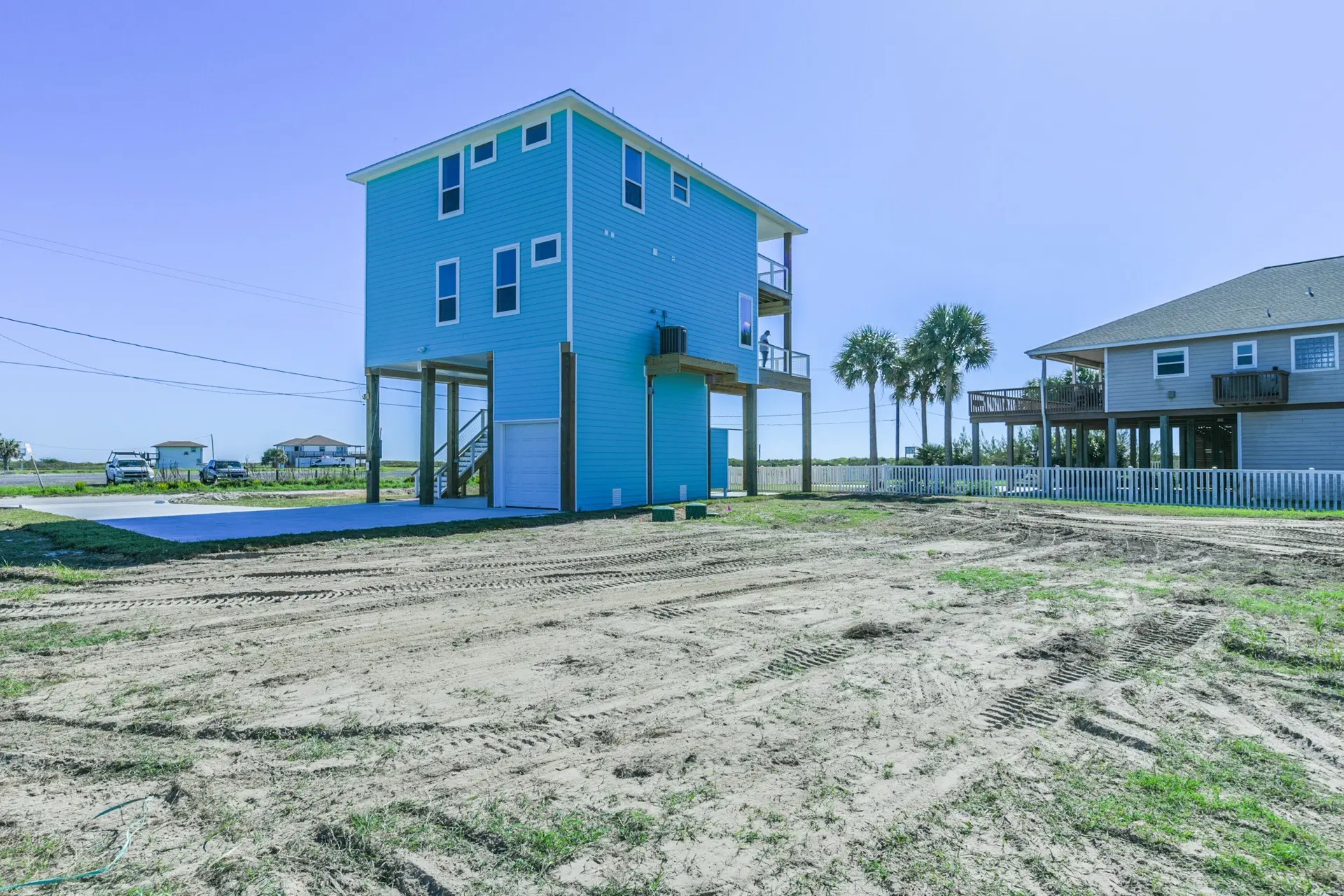 Side view of 4003 Pirates Beach showing multi-level coastal architecture and piling foundation