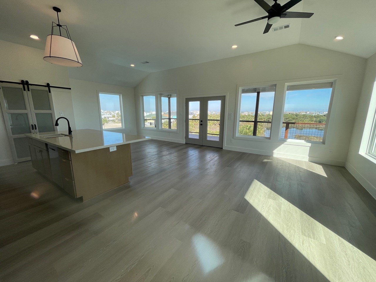 Primary bathroom with dramatic black marble dual vanity, polished gold and brass faucets, twin arched mirrors, and warm ambient wall sconce lighting