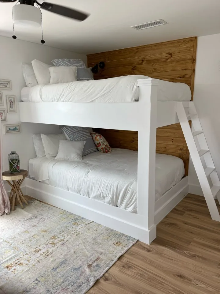 After: custom bunk room at the Flounder renovation with built-in white bunks against a cedar accent wall