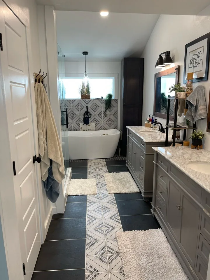 After: freestanding soaking tub in the renovated Flounder primary bath, set against patterned wall tile