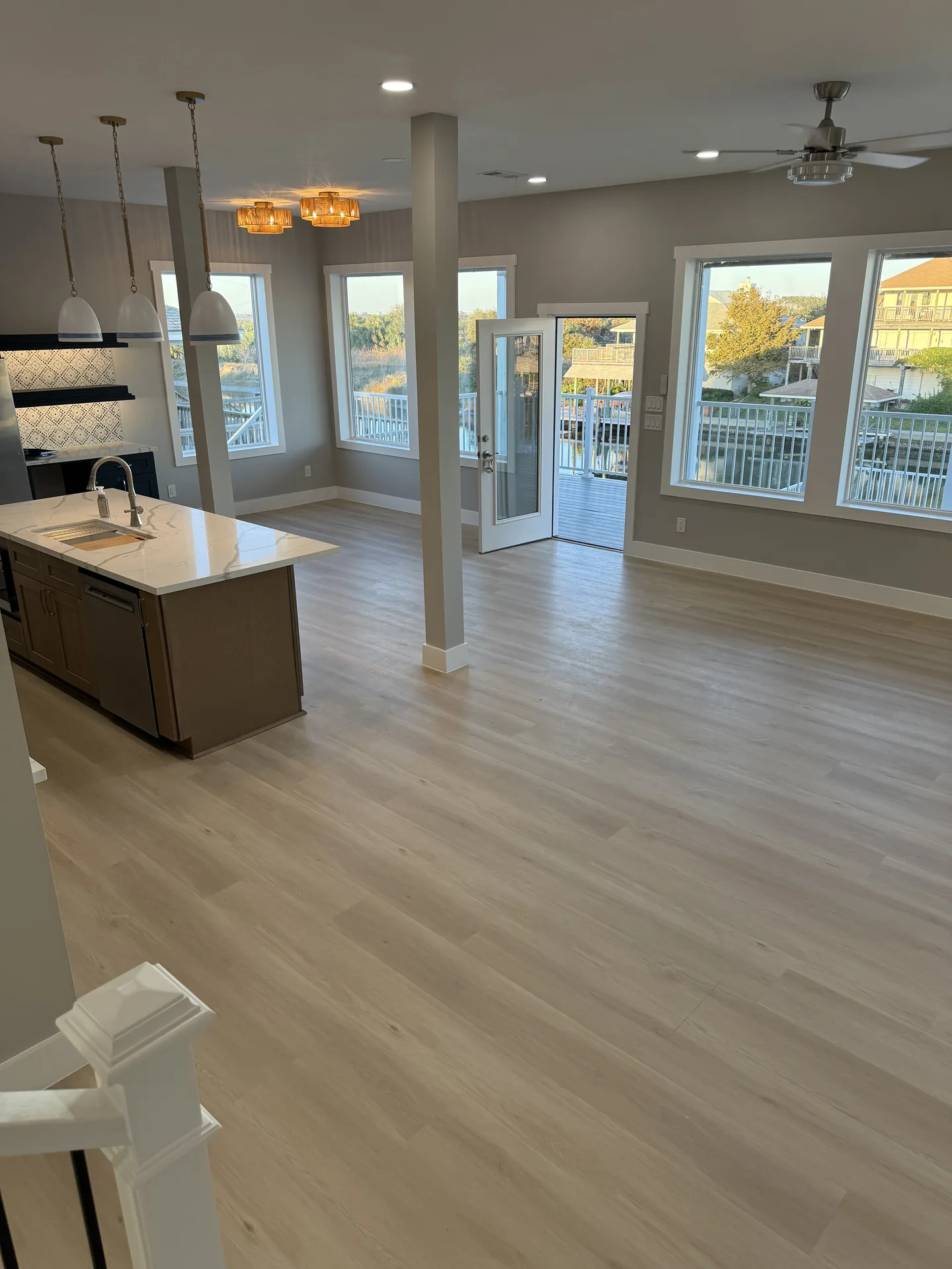 Kitchen island at Galleon topped in quartz with pendant lighting and seating for casual meals