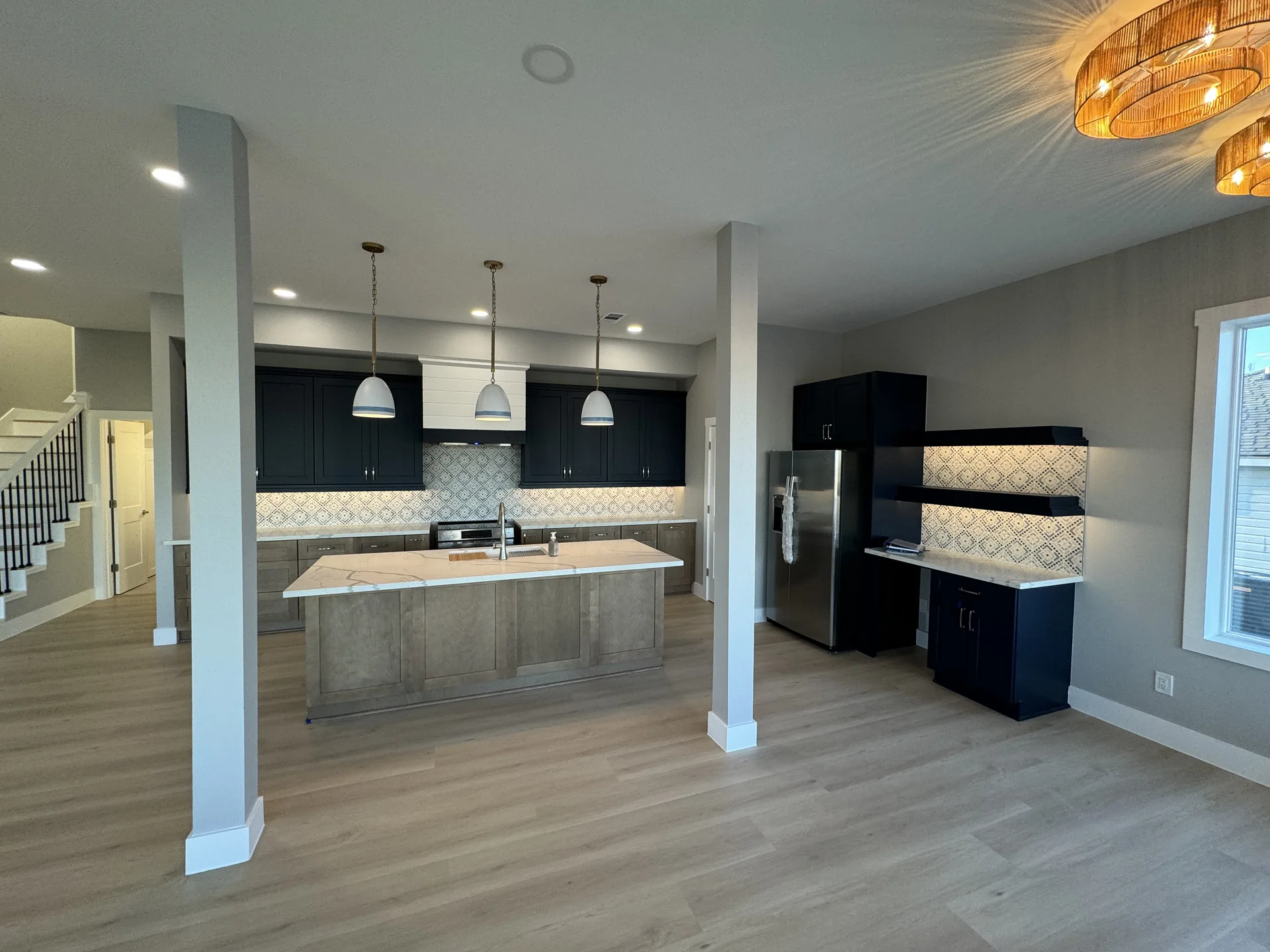 Wide view of the Galleon kitchen showing the full run of cabinetry, island, and adjacent living space