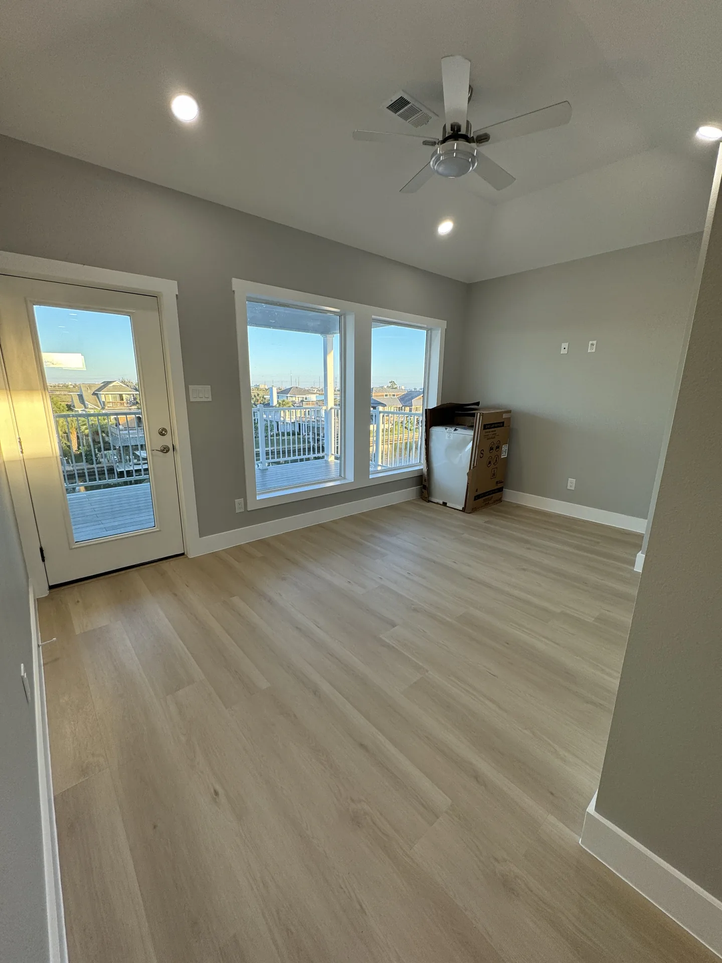 Second living area at Galleon with French doors opening onto the deck and canal views beyond