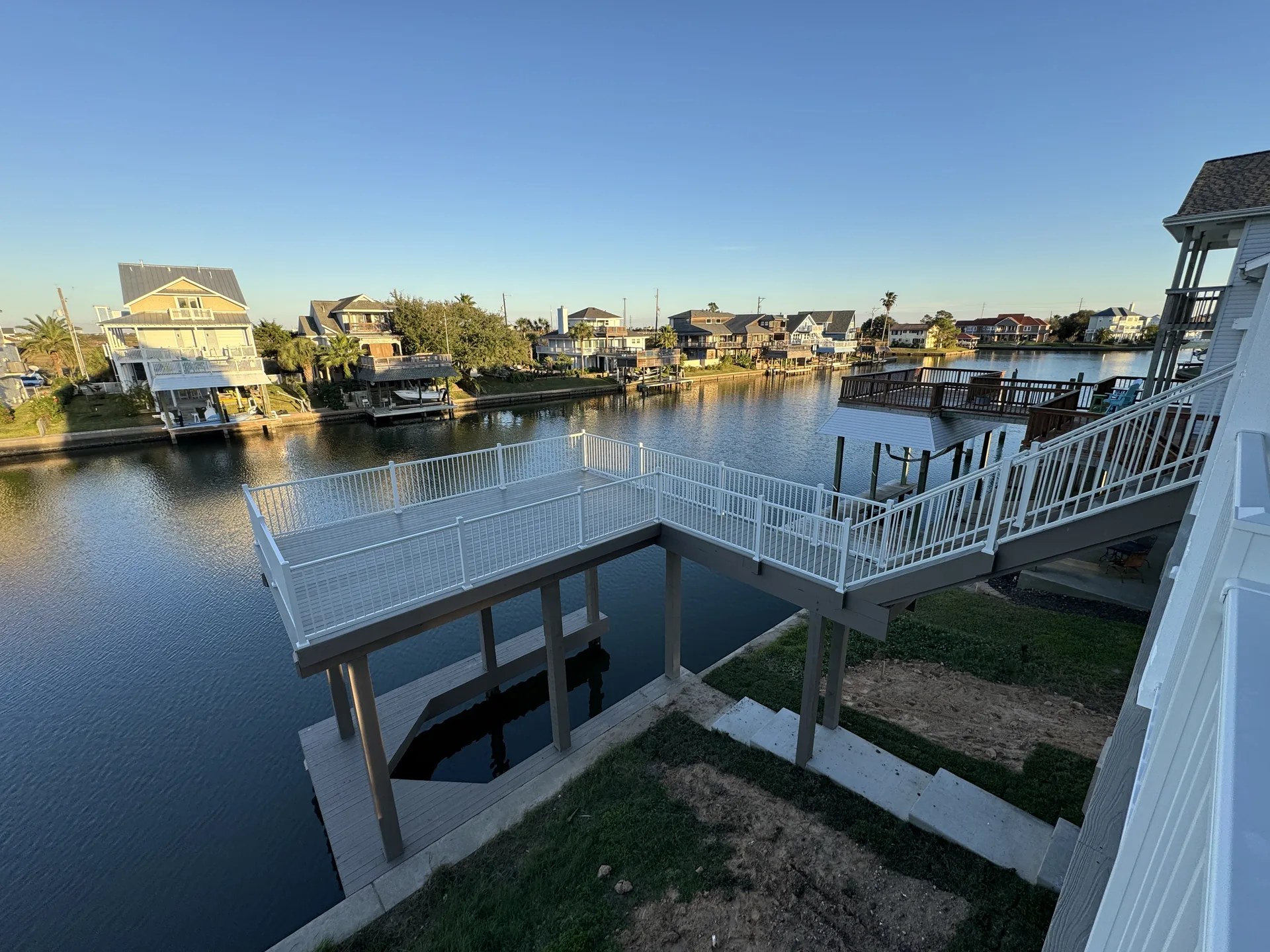 View from the Galleon deck across the Jamaica Beach canal to the private boat dock and neighboring waterfront homes