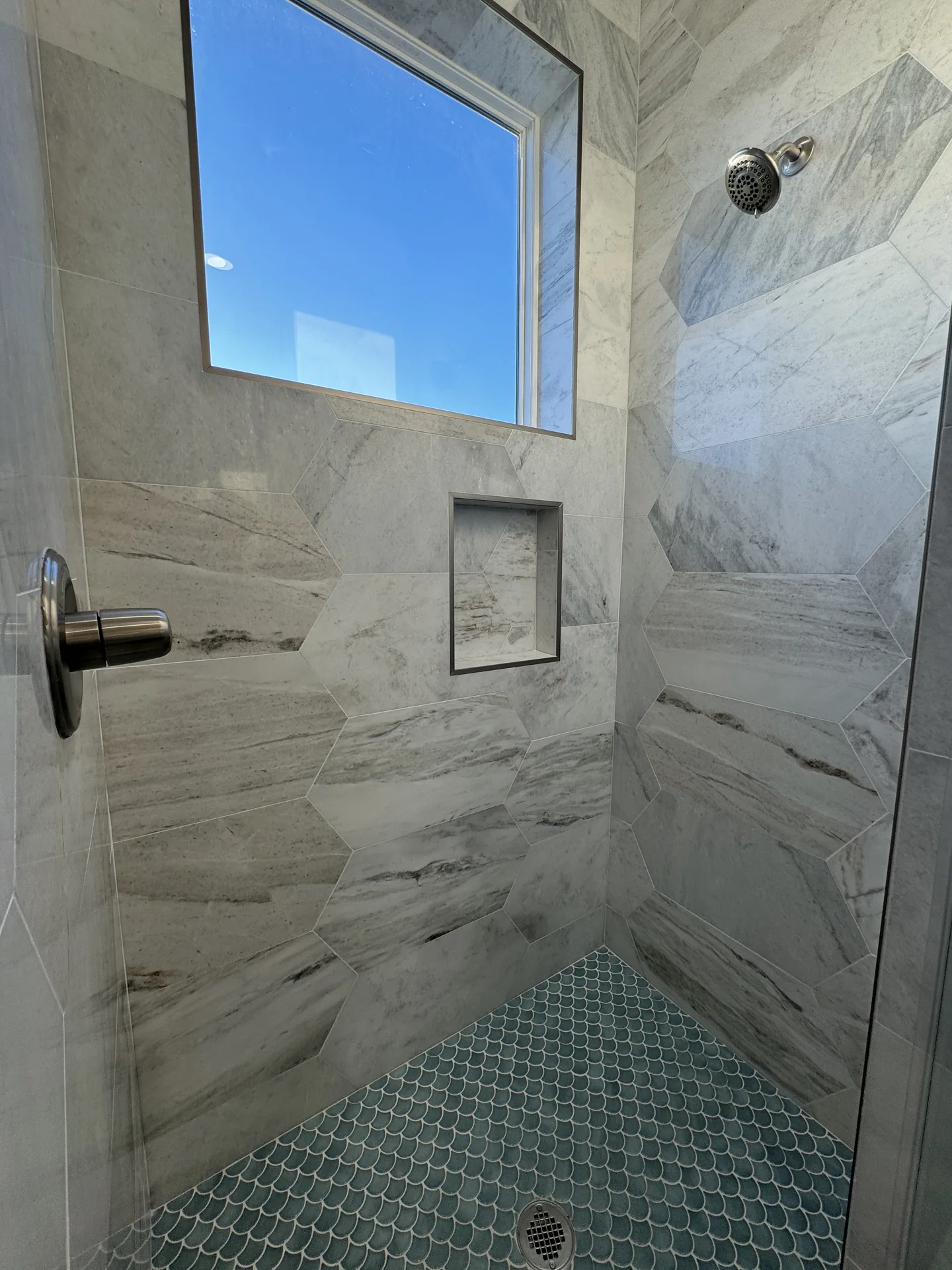 Wide view of the Galleon walk-in shower showing full-height marble-look tile on all three walls
