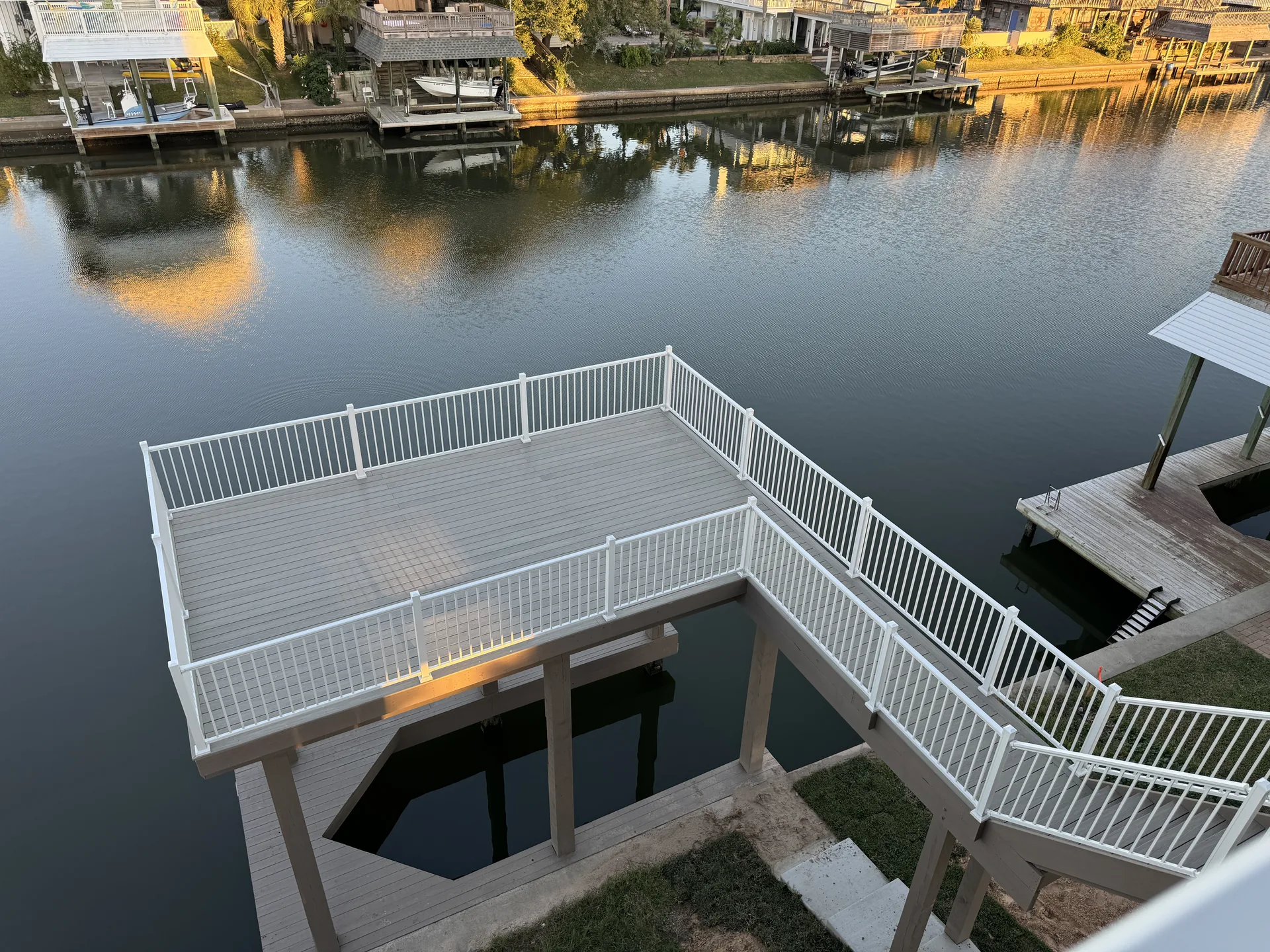 Elevated view of the Galleon waterside deck and dock platform extending over the Jamaica Beach canal