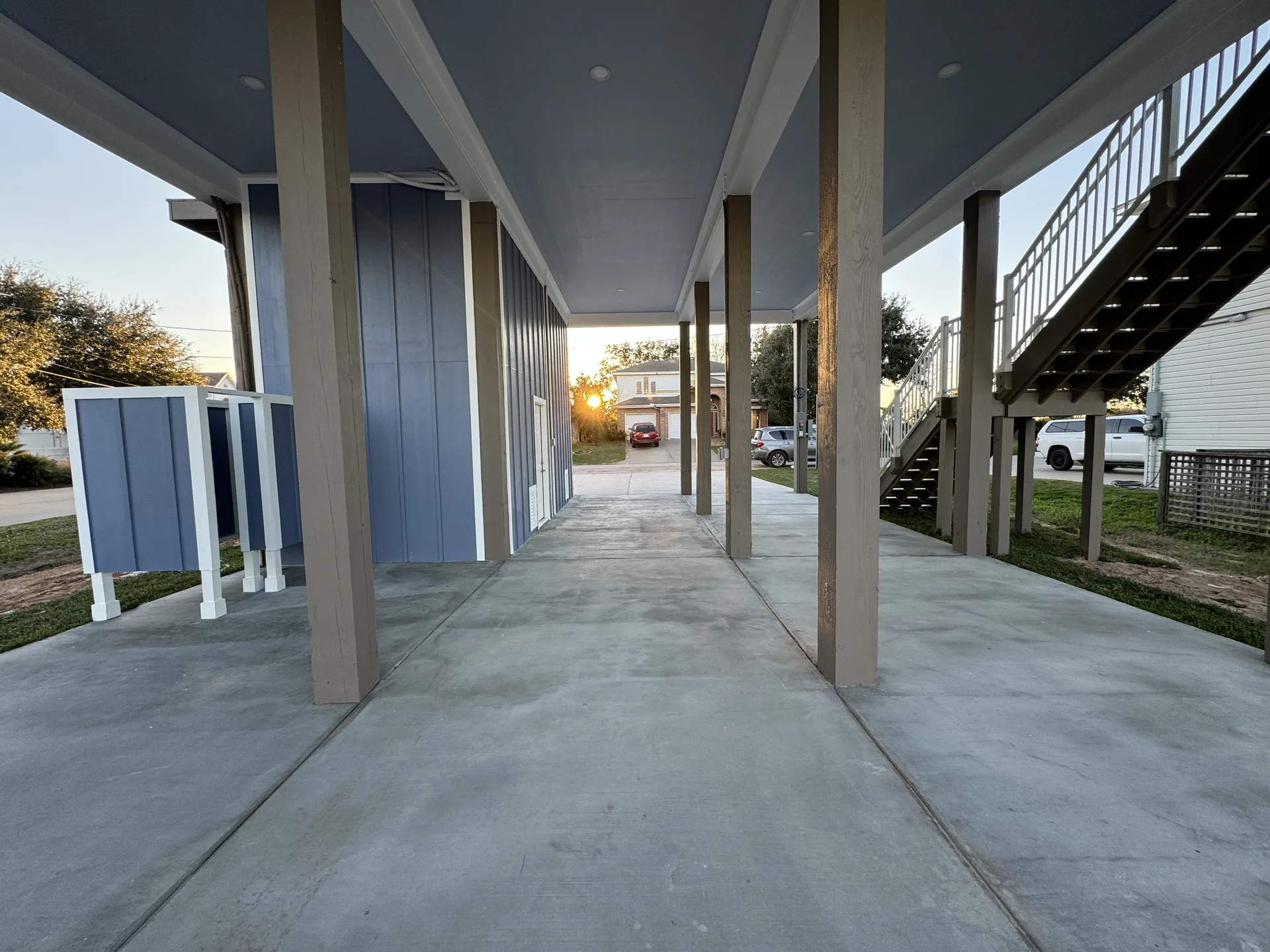 Covered ground-level space under Galleon looking toward the stair tower and the canal beyond