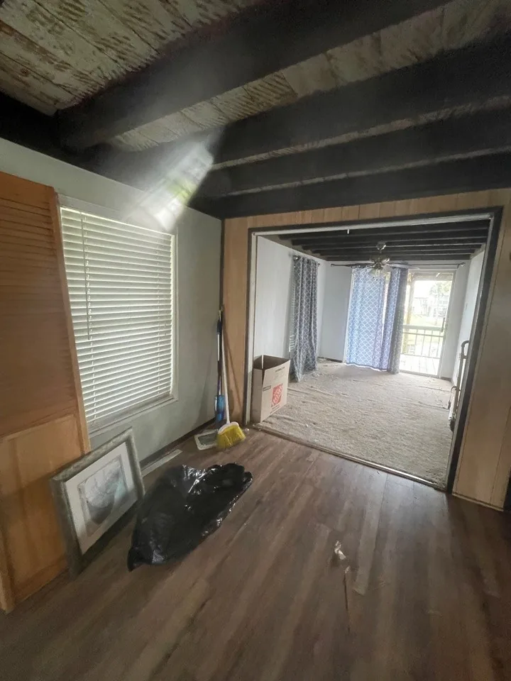 Before: demolition underway with flooring removed and interior walls opened up