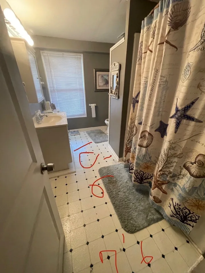 Before: original bathroom marked up in red for demolition and reconfiguration