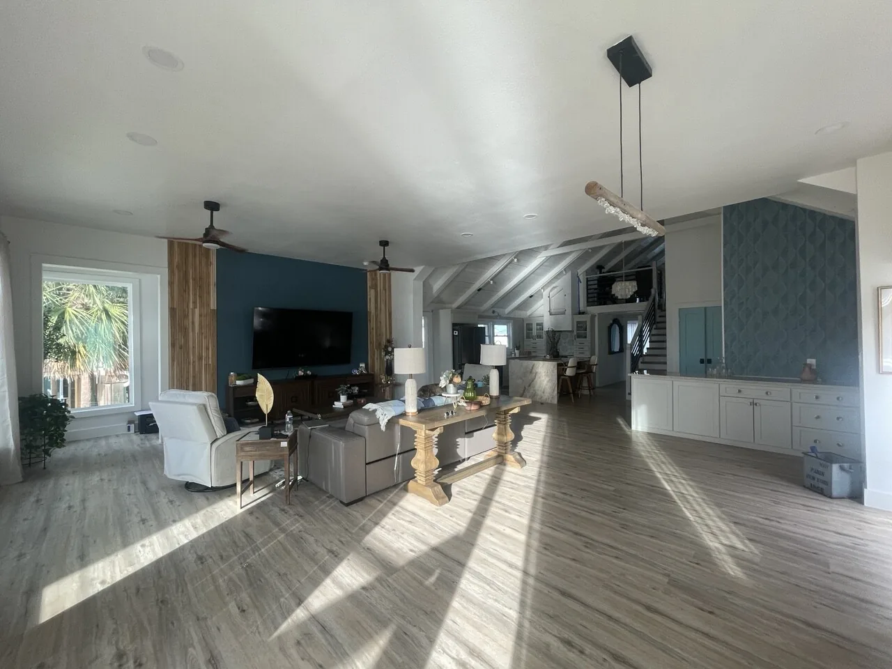 After: great room at the Jamaica Beach renovation looking toward the new kitchen and blue accent wall