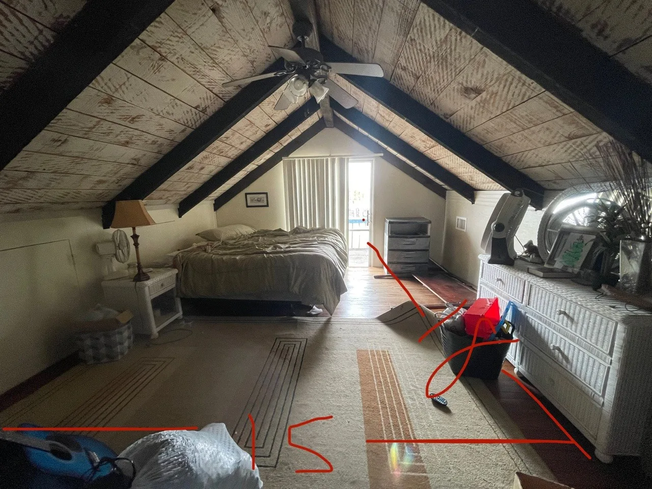 Before: original upstairs bedroom tucked under the dark A-frame with a low knee wall