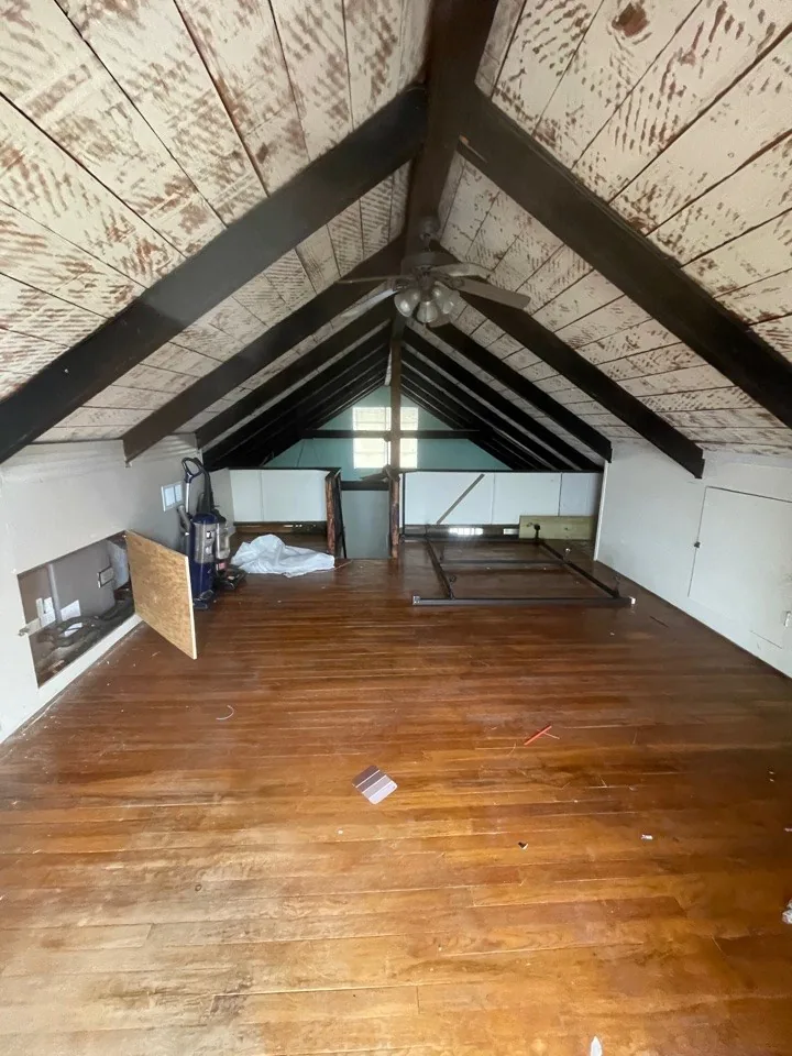 Before: the house gutted to the framing, with the A-frame structure and subfloor exposed