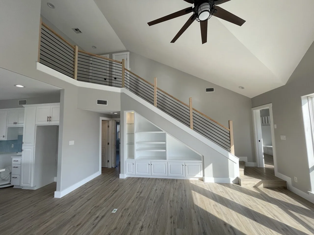 After: renovated great room and staircase at Tern with a horizontal open rail and built-in cabinetry