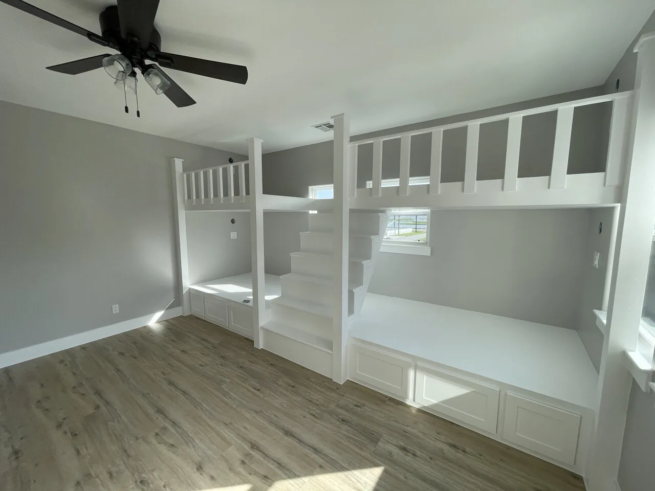 After: custom bunk room at Tern with built-in white bunks, integrated stair, and window openings