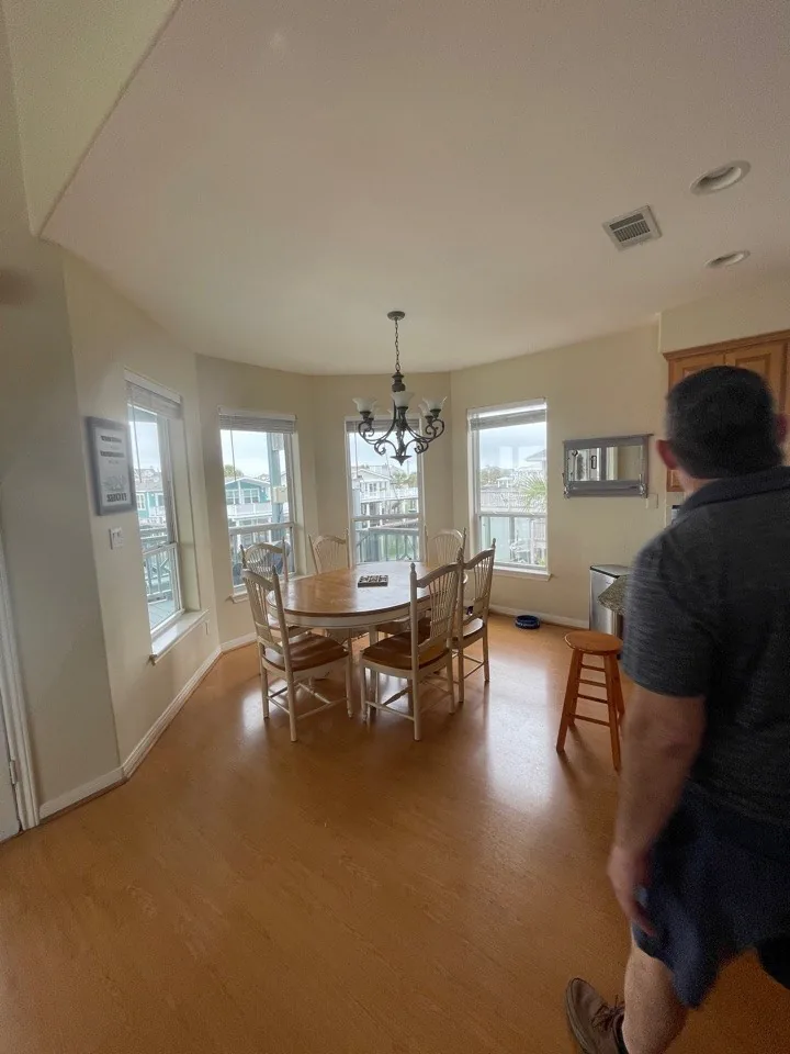 Before: original dining area with a brass chandelier and oak flooring