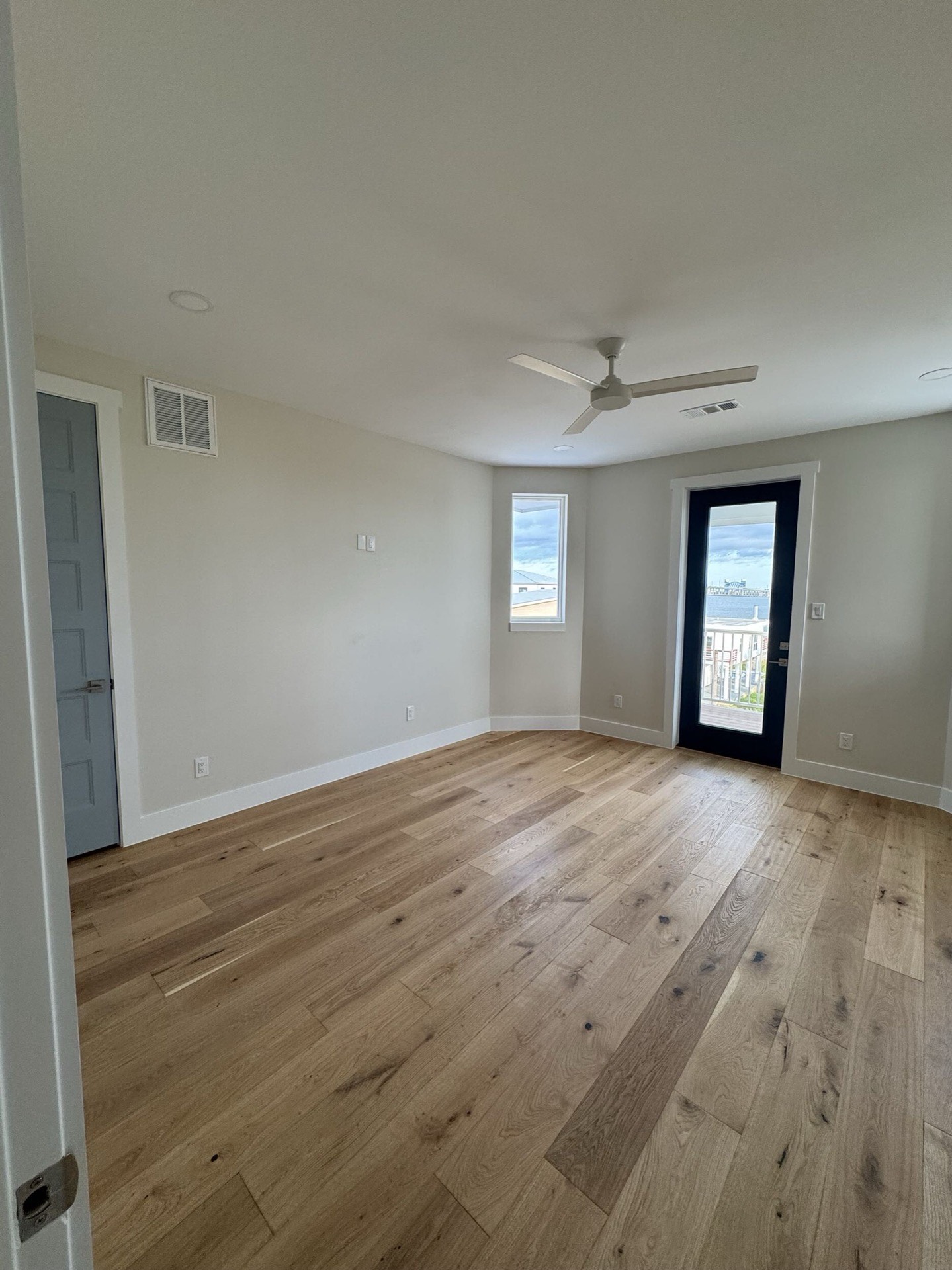 Reading nook or sitting area with built-in details, oak floors, and natural light from multiple windows in the West Bay Craftsman