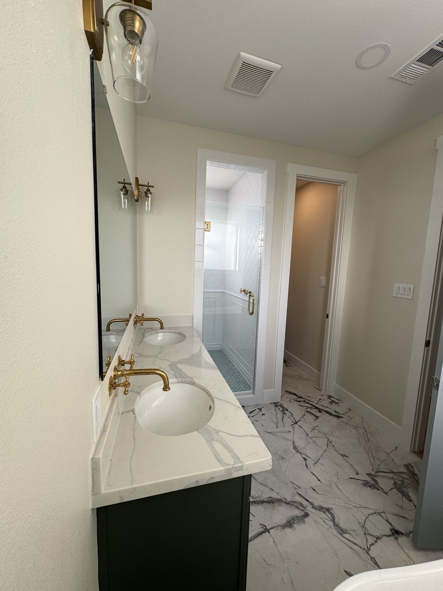Entryway and hall showing crown molding detail, oak hardwood floors, and traditional coastal Craftsman millwork throughout the home