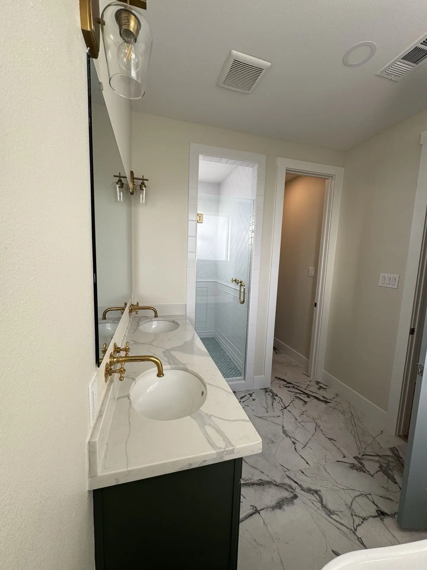 Entryway and hall showing crown molding detail, oak hardwood floors, and traditional coastal Craftsman millwork throughout the home