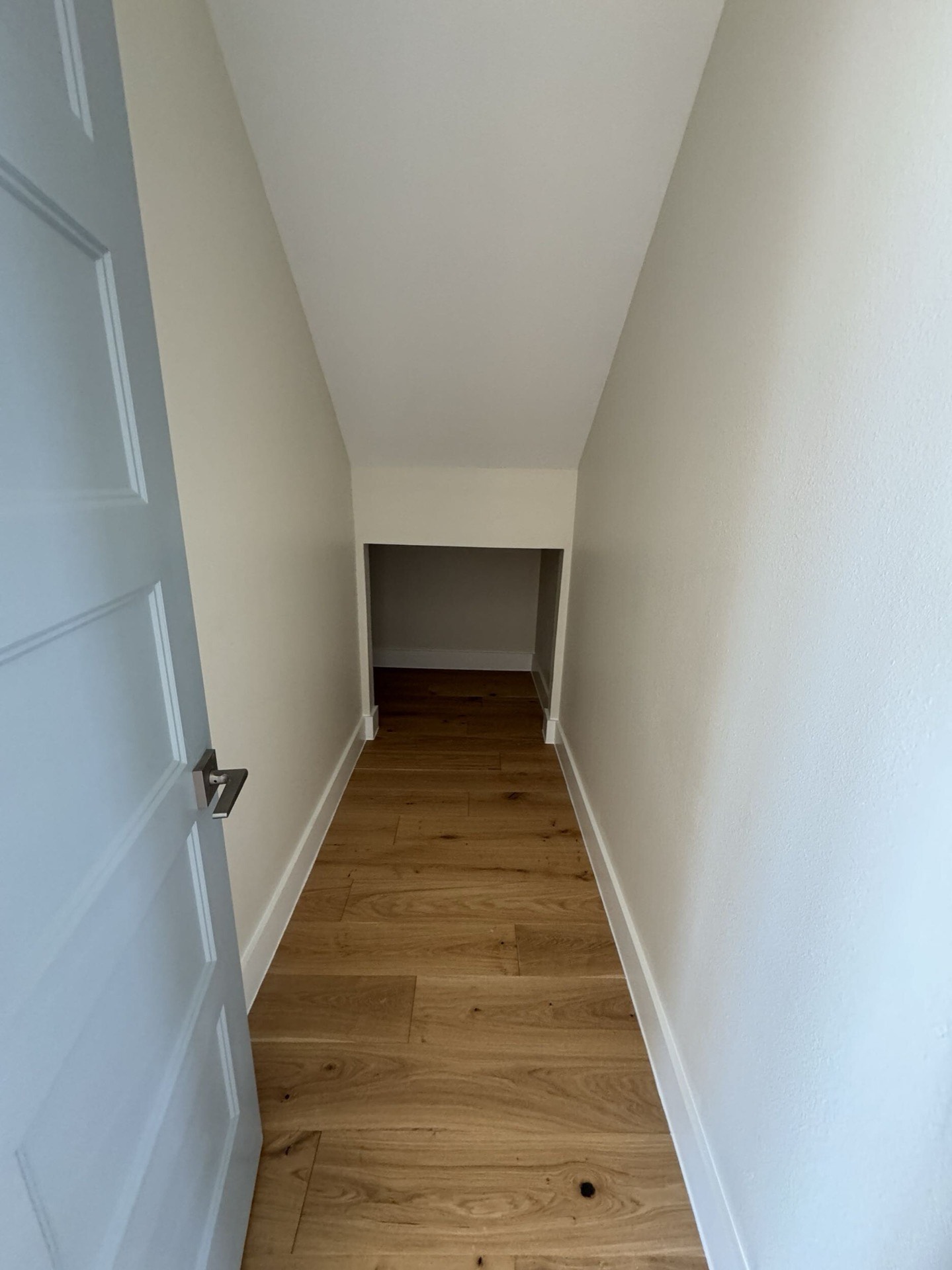 Kitchen featuring sage green cabinetry, stainless steel double wall ovens, glass-front upper cabinets, and natural oak hardwood flooring