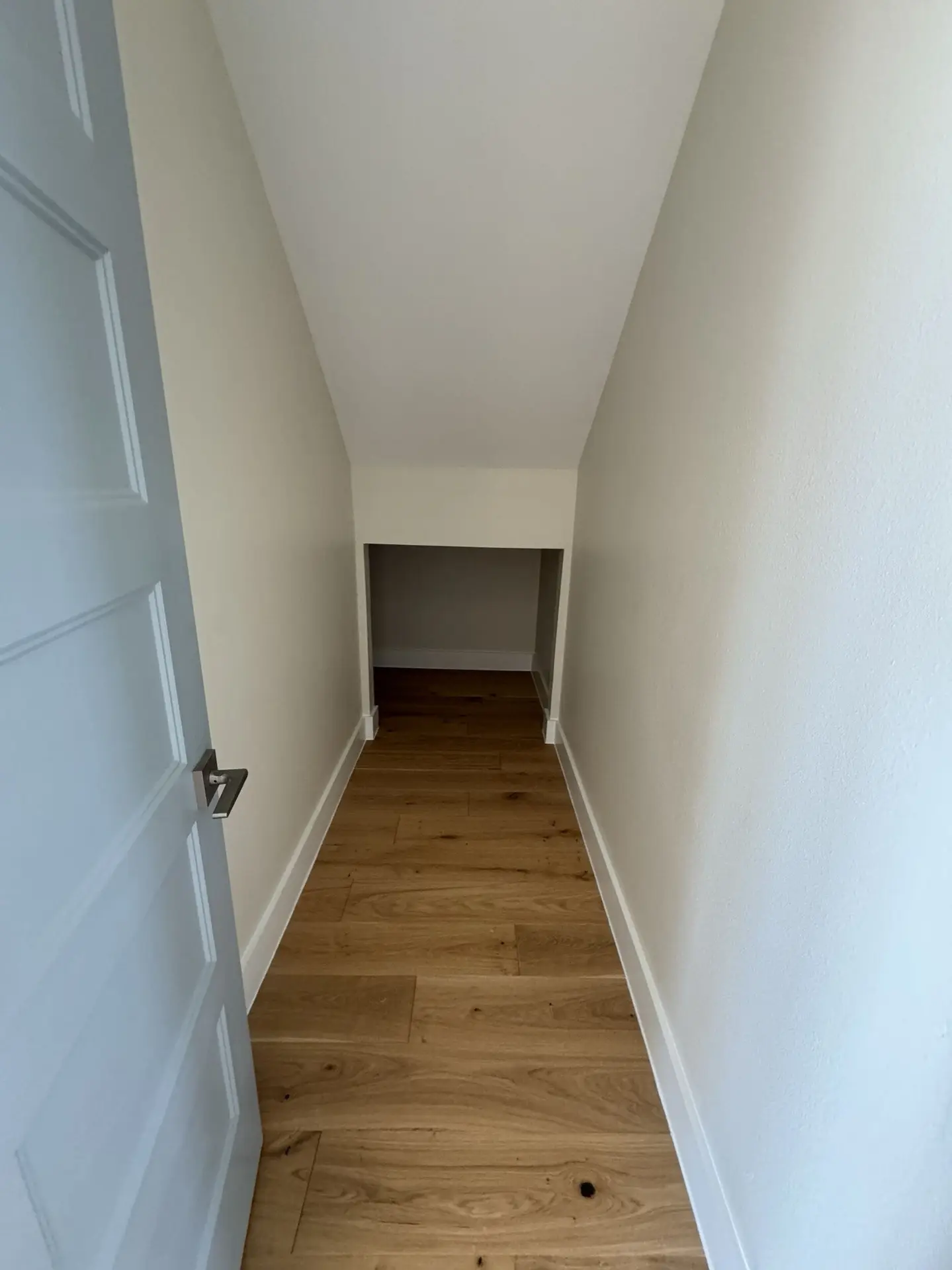 Kitchen featuring sage green cabinetry, stainless steel double wall ovens, glass-front upper cabinets, and natural oak hardwood flooring